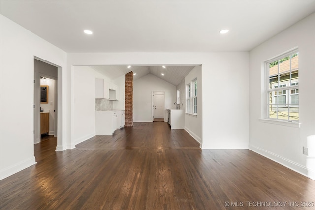 1166 N Boston Pl, Tulsa, OK 74106 - unfurnished living room with dark wood-type flooring, recessed lighting, baseboards, and lofted ceiling