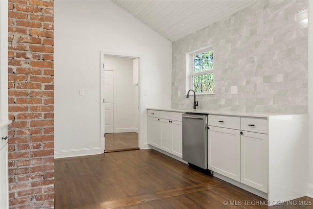 1166 N Boston Pl, Tulsa, OK 74106 - kitchen with stainless steel dishwasher, lofted ceiling, light countertops, white cabinetry, and a sink