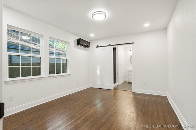 1166 N Boston Pl, Tulsa, OK 74106 - interior space with baseboards, a barn door, wood finished floors, and a wall mounted air conditioner