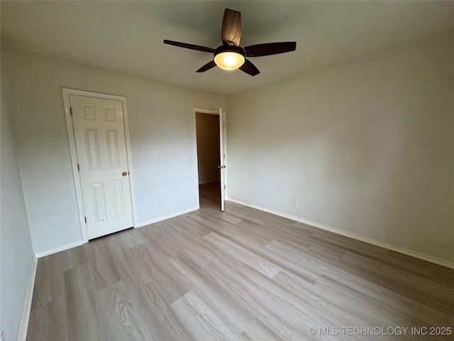 unfurnished bedroom featuring a ceiling fan, baseboards, and wood finished floors