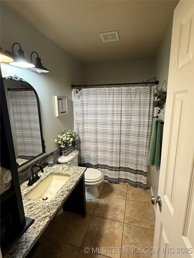 bathroom featuring a shower with curtain, visible vents, tile patterned flooring, vanity, and toilet