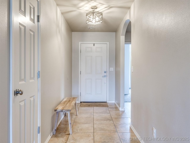 4312 N 33rd St, Broken Arrow, OK 74014 - doorway with arched walkways, baseboards, visible vents, and light tile patterned floors