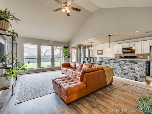 4312 N 33rd St, Broken Arrow, OK 74014 - living room with high vaulted ceiling, light wood-style flooring, ceiling fan with notable chandelier, recessed lighting, and visible vents
