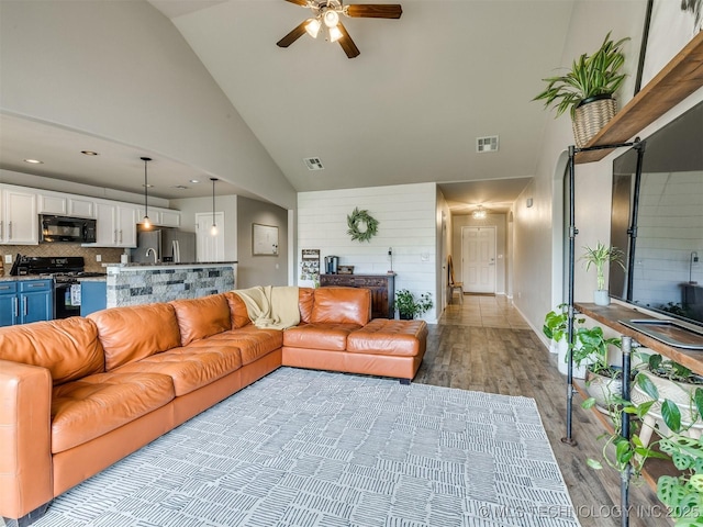 4312 N 33rd St, Broken Arrow, OK 74014 - living area featuring high vaulted ceiling, visible vents, ceiling fan, and light wood-type flooring