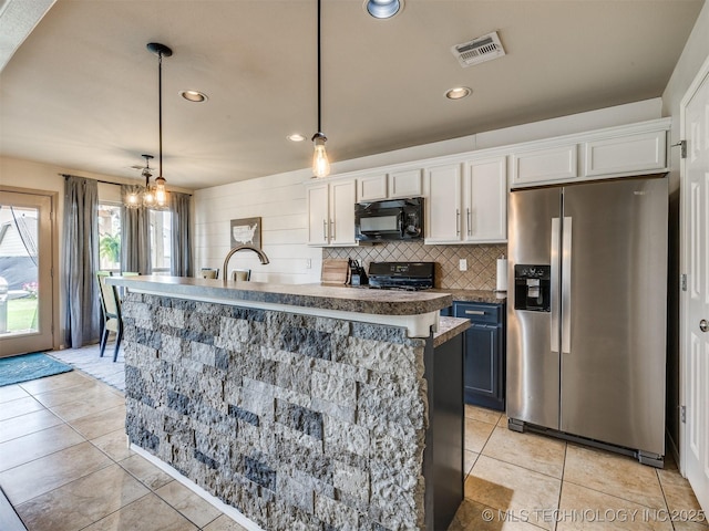 4312 N 33rd St, Broken Arrow, OK 74014 - kitchen featuring visible vents, an island with sink, white cabinetry, light tile patterned floors, and black appliances