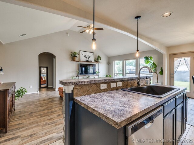 4312 N 33rd St, Broken Arrow, OK 74014 - kitchen featuring a sink, dishwasher, arched walkways, vaulted ceiling, and visible vents