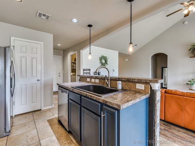 4312 N 33rd St, Broken Arrow, OK 74014 - kitchen featuring appliances with stainless steel finishes, a sink, arched walkways, open floor plan, and visible vents