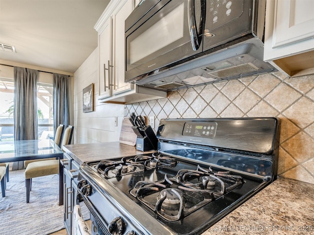 4312 N 33rd St, Broken Arrow, OK 74014 - kitchen with range with gas cooktop, backsplash, visible vents, black microwave, and white cabinetry