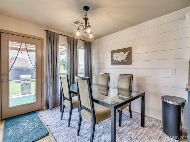 4312 N 33rd St, Broken Arrow, OK 74014 - dining room with visible vents, wooden walls, and a notable chandelier
