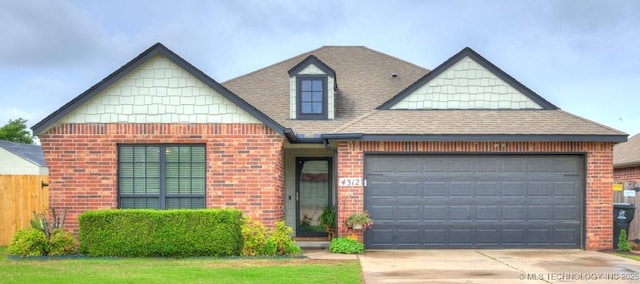 4312 N 33rd St, Broken Arrow, OK 74014 - view of front of house featuring a shingled roof, an attached garage, driveway, and brick siding