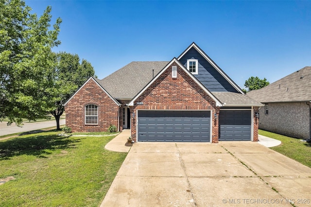 view of front of house with brick siding, a garage, driveway, and a front yard