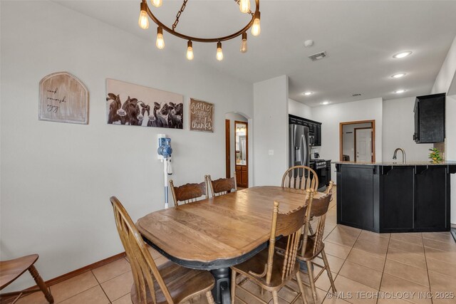 dining room with arched walkways, recessed lighting, light tile patterned flooring, and visible vents