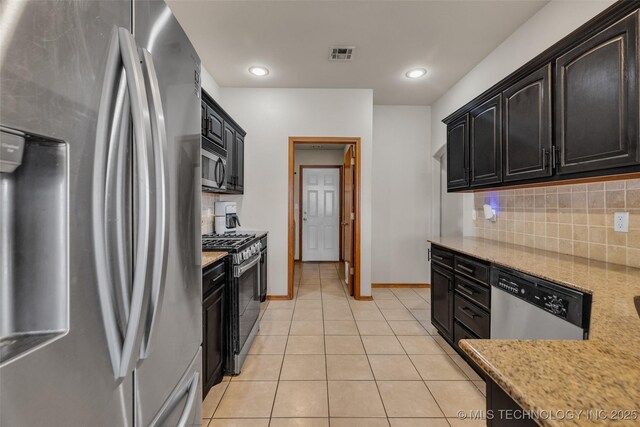 kitchen featuring dark cabinetry, appliances with stainless steel finishes, and visible vents