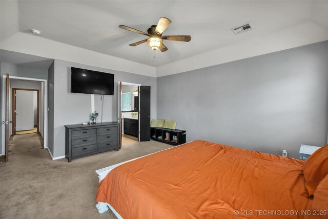 bedroom with visible vents, baseboards, light colored carpet, a ceiling fan, and ensuite bath