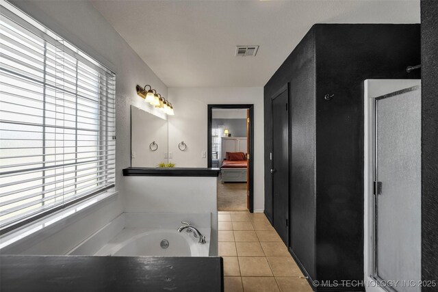full bathroom featuring a bath, visible vents, tile patterned flooring, and ensuite bath
