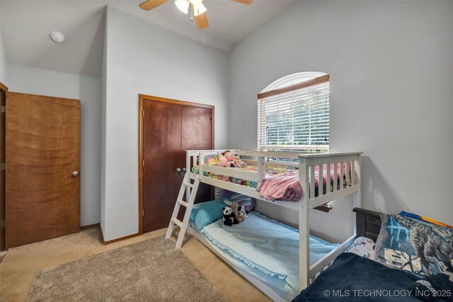 carpeted bedroom featuring ceiling fan and vaulted ceiling