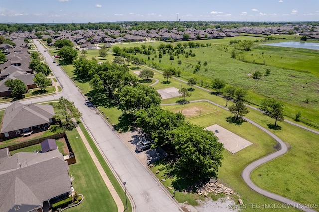 birds eye view of property featuring a water view and a residential view
