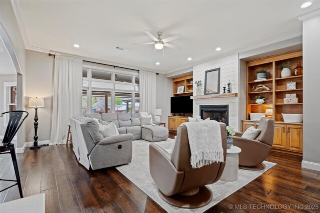 living room with visible vents, baseboards, ceiling fan, and dark wood-style floors