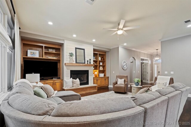 living room with dark wood-style flooring, baseboards, recessed lighting, and ornamental molding