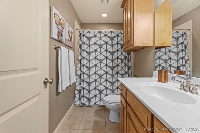 bathroom featuring tile patterned flooring, vanity, toilet, baseboards, and visible vents
