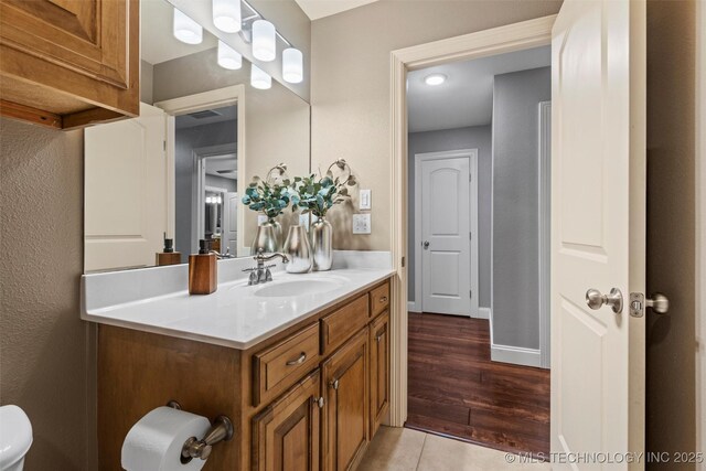 bathroom with vanity and wood finished floors