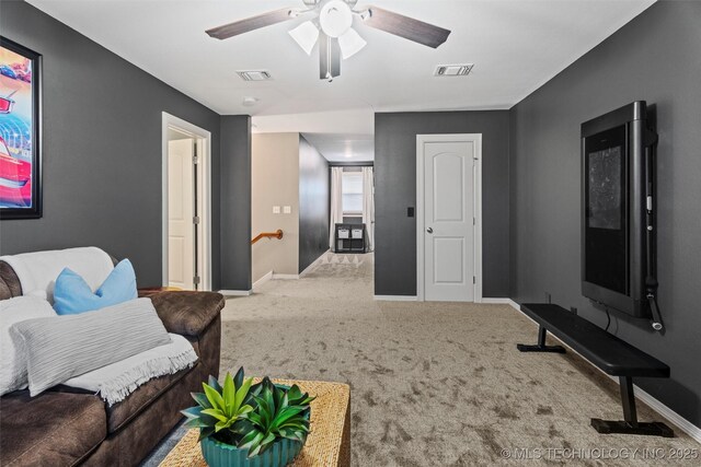 carpeted living room with visible vents, baseboards, and ceiling fan