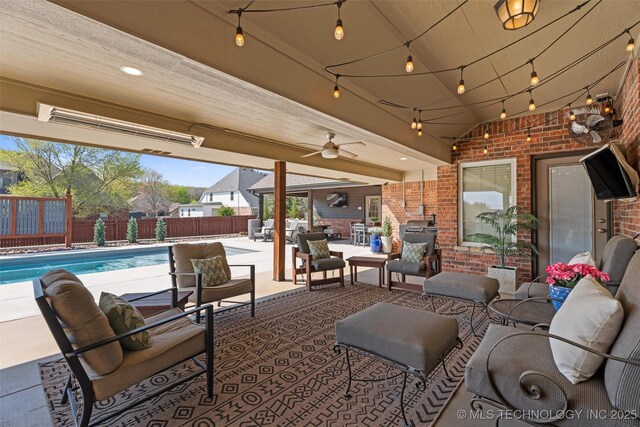 view of patio / terrace with outdoor lounge area, a ceiling fan, a fenced backyard, and a fenced in pool