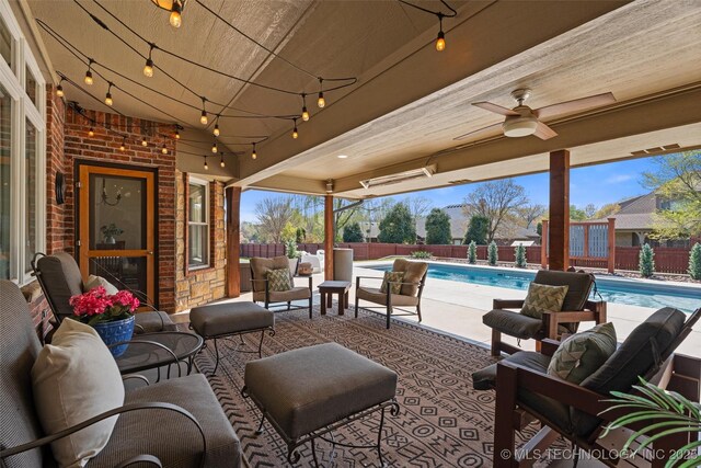view of patio / terrace with ceiling fan, an outdoor living space, a fenced backyard, and a fenced in pool