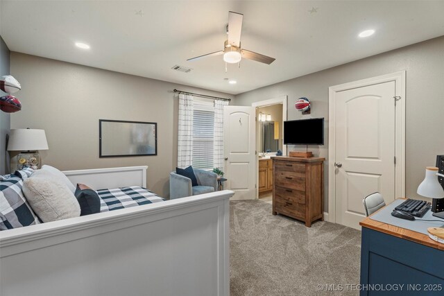 bedroom with ensuite bathroom, light carpet, recessed lighting, and visible vents