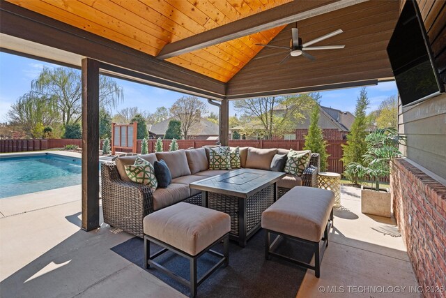 view of patio featuring a fenced in pool, a fenced backyard, ceiling fan, and an outdoor hangout area