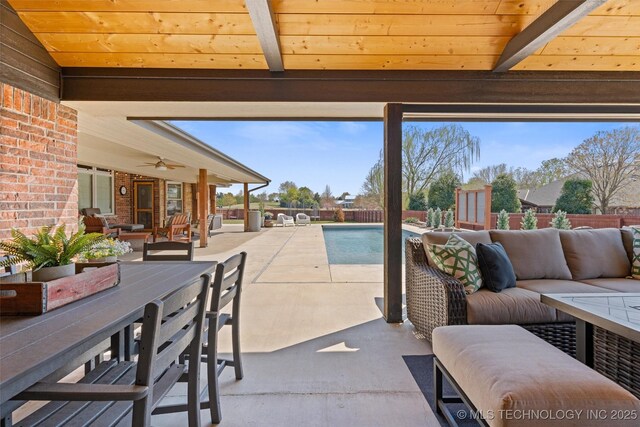 view of patio with ceiling fan, an outdoor living space, outdoor dining area, fence, and a fenced in pool