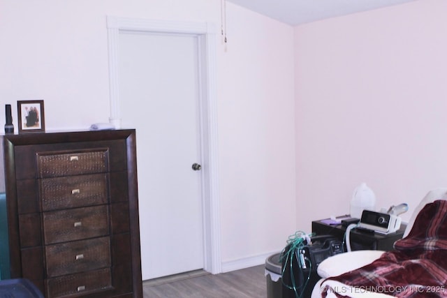 interior space with baseboards and wood finished floors