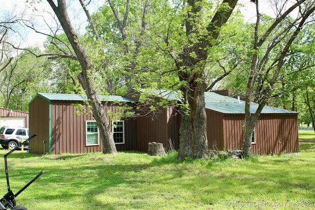 1005 N Osage St, Chouteau, OK 74337 - view of green lawn with an outbuilding and a garage