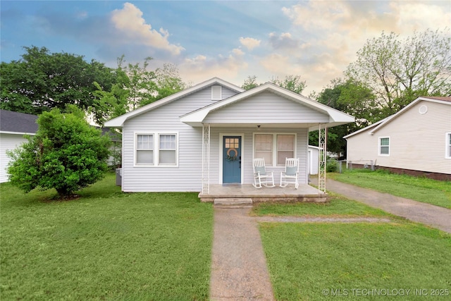 bungalow with a porch and a front yard