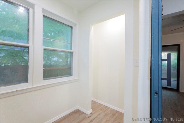 interior space featuring baseboards and wood finished floors