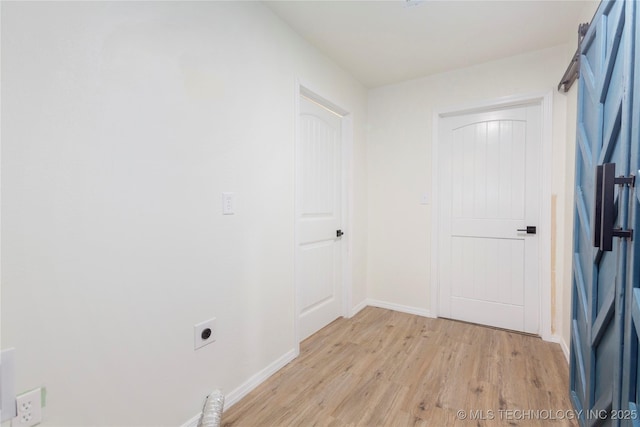interior space featuring baseboards and light wood-style flooring