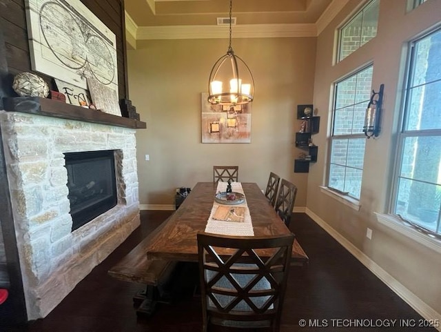 dining area featuring visible vents, ornamental molding, a wealth of natural light, and a fireplace
