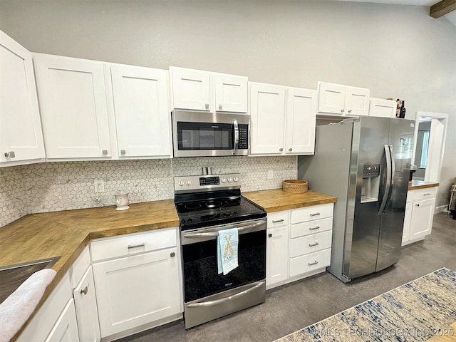 kitchen featuring backsplash, white cabinetry, appliances with stainless steel finishes, and wooden counters