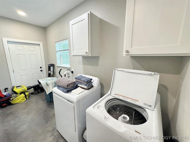 laundry area featuring cabinet space and separate washer and dryer