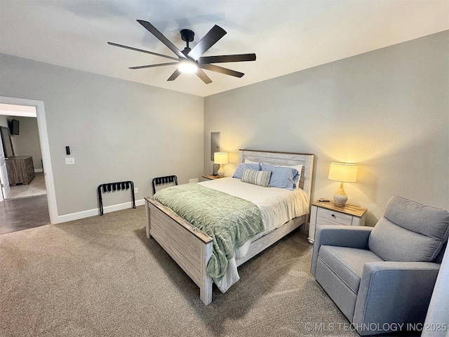 carpeted bedroom featuring a ceiling fan and baseboards