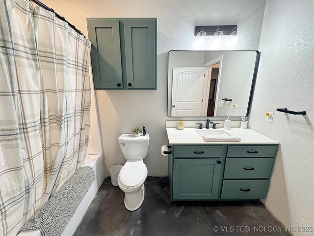bathroom featuring vanity, shower / bath combo, and toilet