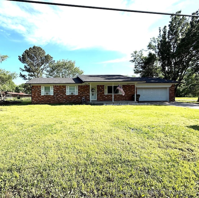 ranch-style house with an attached garage, brick siding, driveway, and a front yard
