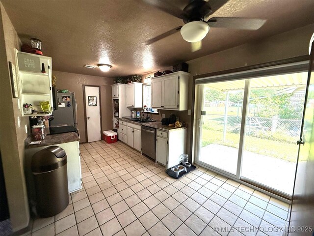 101 E Corporation St, Henryetta, OK 74437 - kitchen featuring white cabinets, ceiling fan, dark countertops, a sink, and a textured ceiling