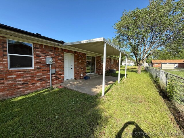 101 E Corporation St, Henryetta, OK 74437 - view of yard featuring central air condition unit, fence, and a patio area