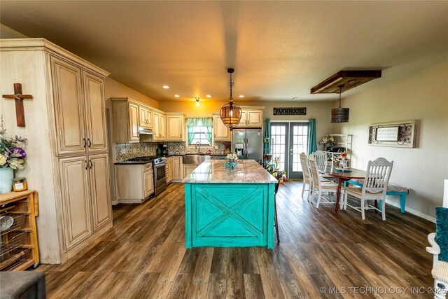 kitchen featuring light stone counters, appliances with stainless steel finishes, dark wood-style floors, and tasteful backsplash