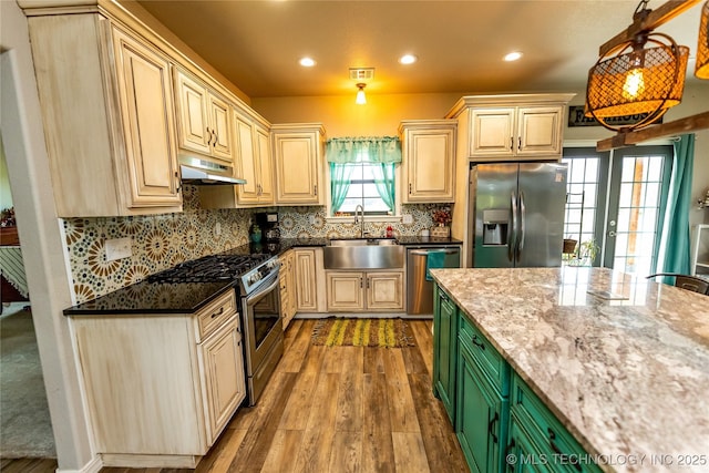 kitchen featuring a sink, light wood-style floors, stainless steel appliances, recessed lighting, and under cabinet range hood