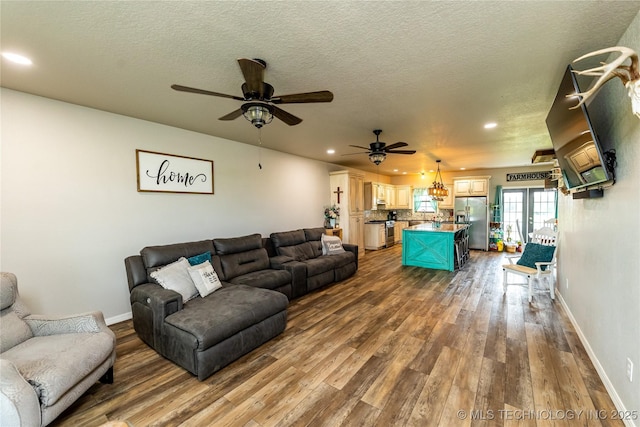 living room with recessed lighting, baseboards, ceiling fan, and dark wood-style flooring