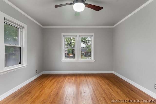spare room featuring a ceiling fan, baseboards, ornamental molding, and light wood-type flooring