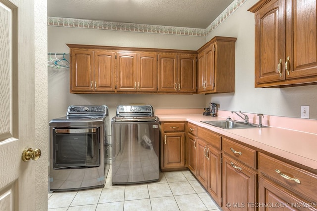 13303 E 95th Pl N, Owasso, OK 74055 - clothes washing area featuring independent washer and dryer, light tile patterned flooring, a sink, and cabinet space