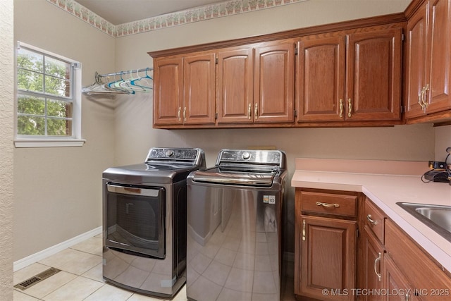 13303 E 95th Pl N, Owasso, OK 74055 - washroom featuring cabinet space, independent washer and dryer, baseboards, light tile patterned floors, and visible vents